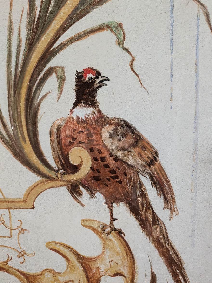 Hand-painted rococo fresco detail — a pheasant among gilded scrollwork