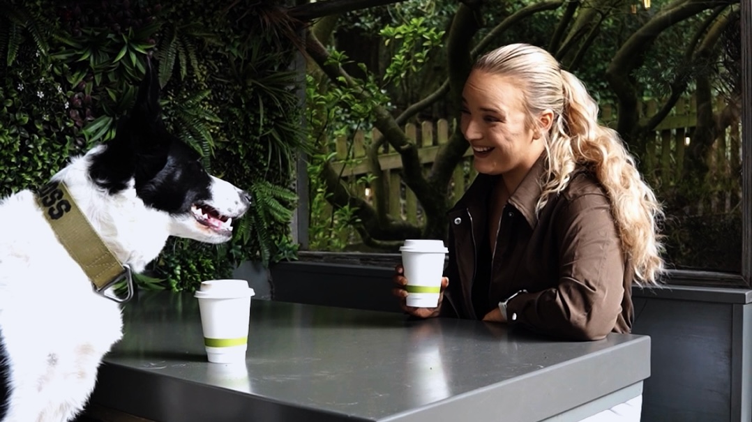 Business owner working away from her desk at a sunlit cafe while her business keeps running
