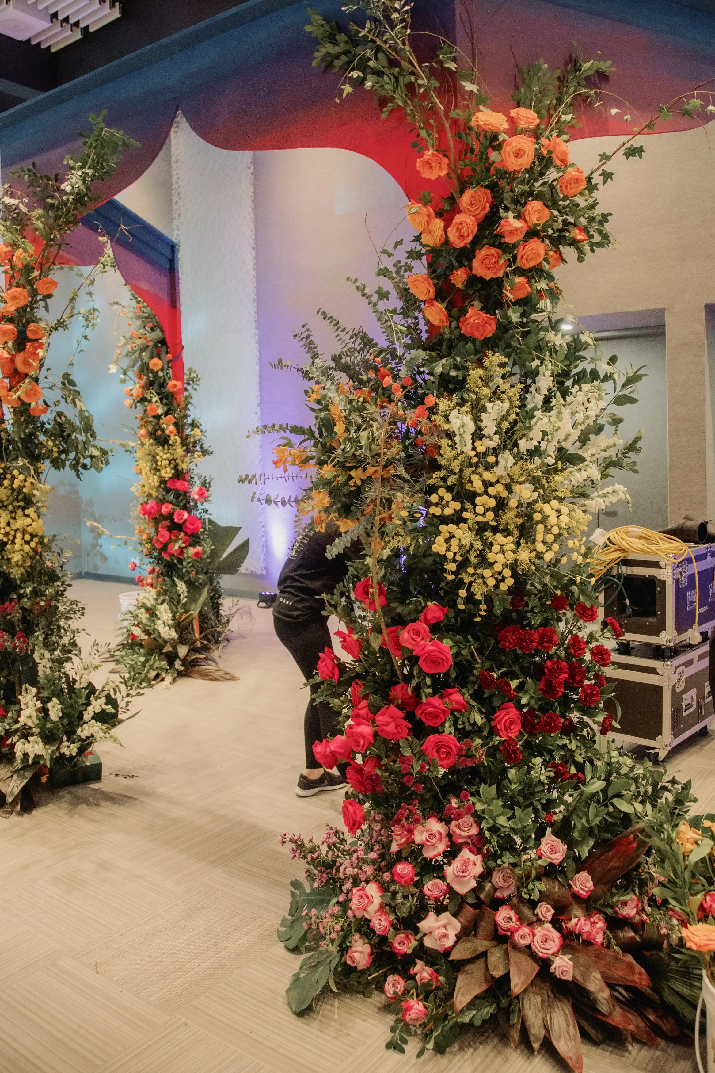 Arco floral de rosas rojas y follaje