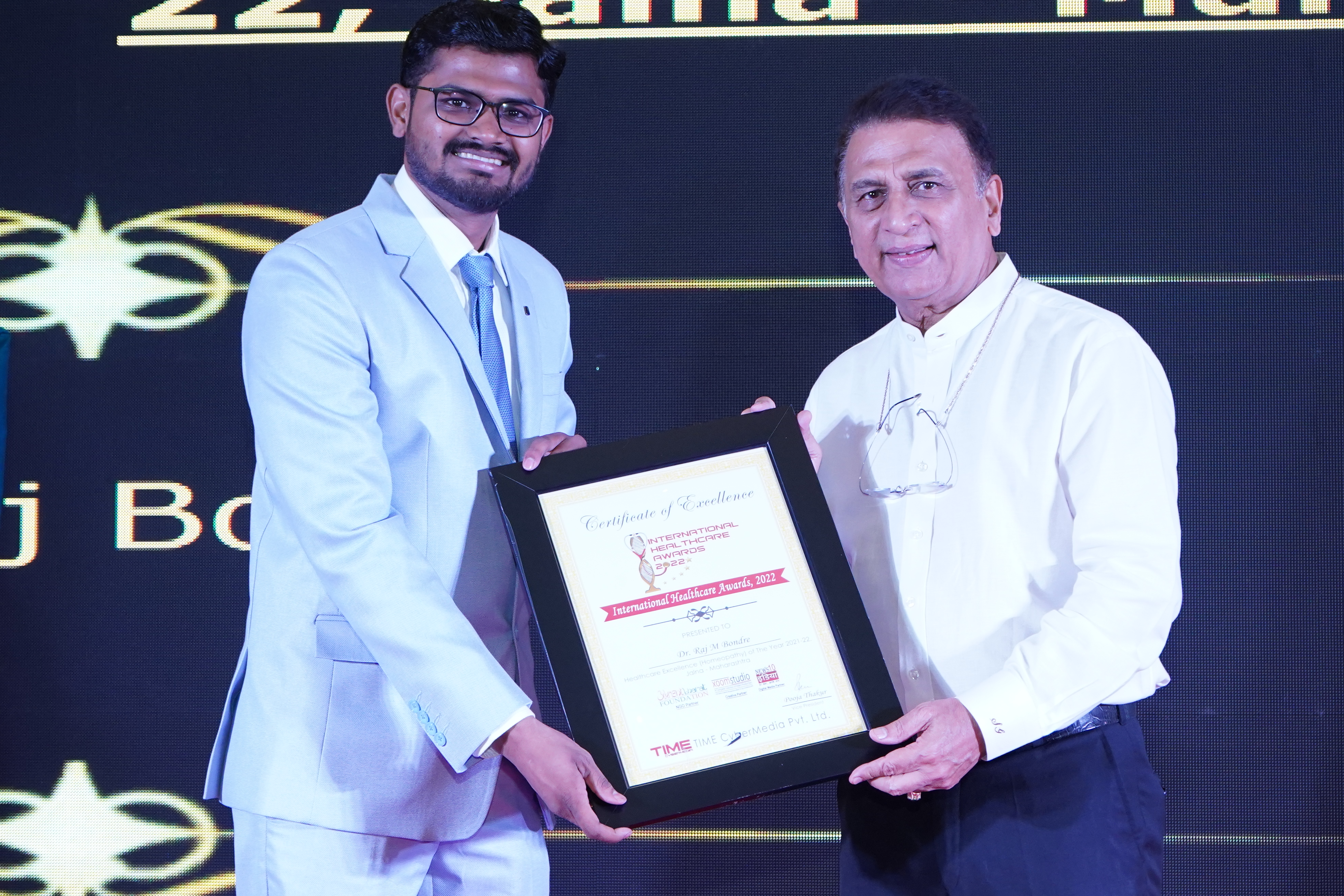 Dr. Raj receiving award