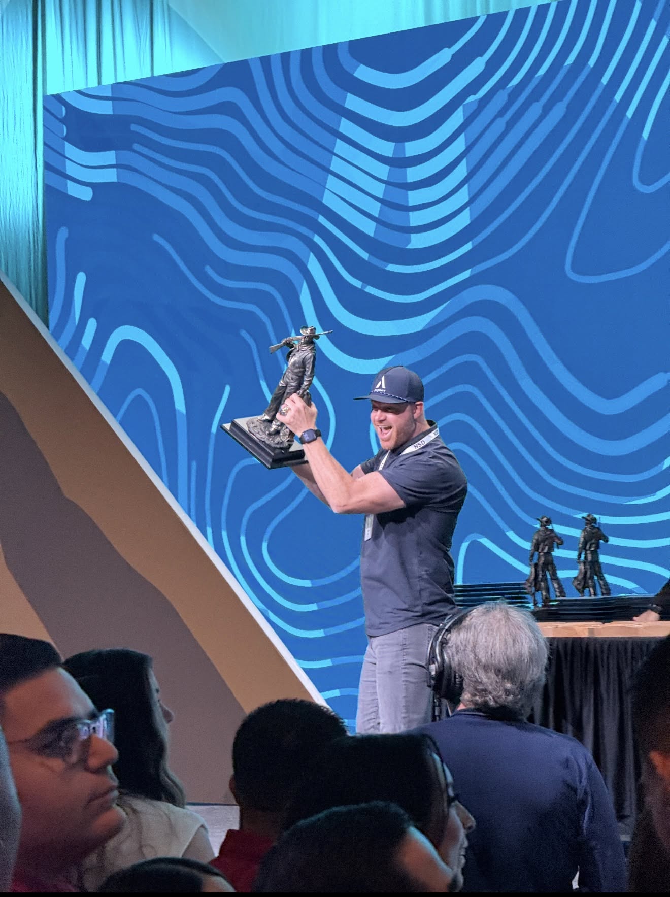 A Summit participant celebrating an event milestone onstage