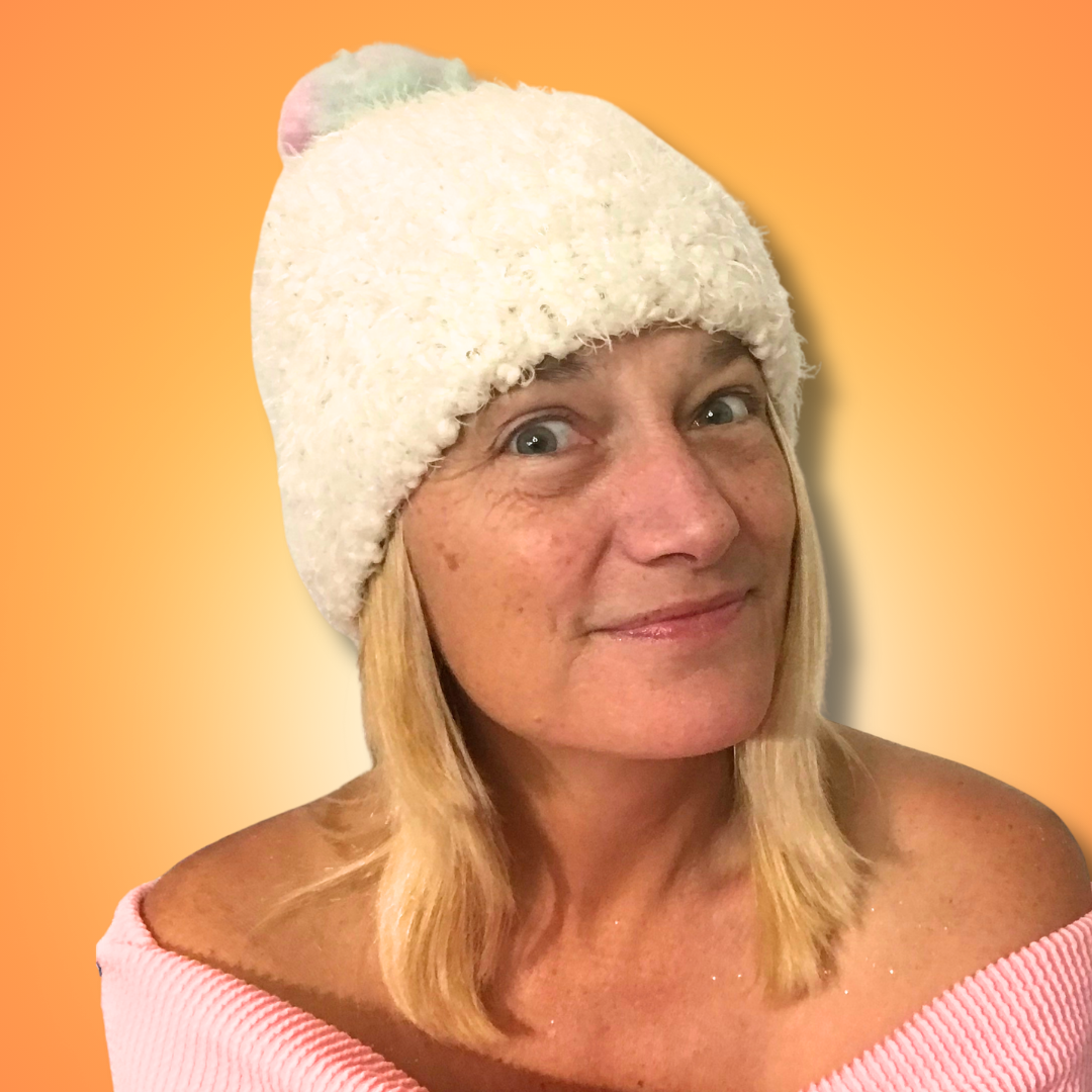Dawn Super, smiling in a white hat, against a soft orange background.