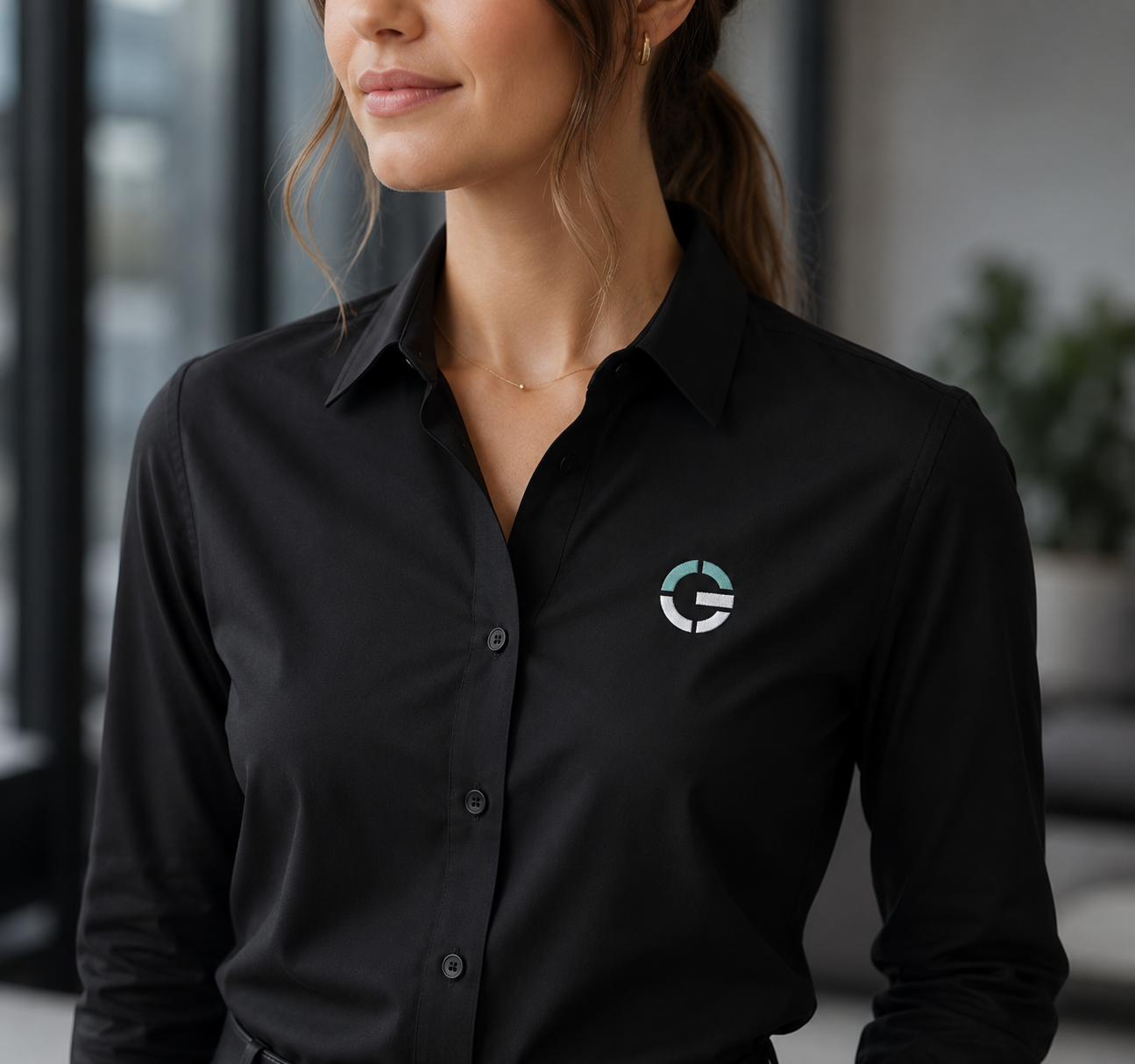 Geoinventions black polo uniform with embroidered teal logo