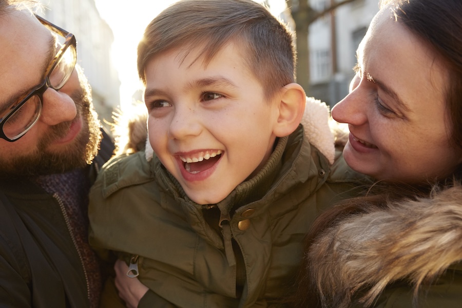 young boy with parents smiling, supported after PANS PANDAS diagnosed young boy with parents smiling, supported after PANS PANDAS diagnosed