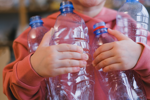 Child Holding Plastic Bottles Child Holding Plastic Bottles