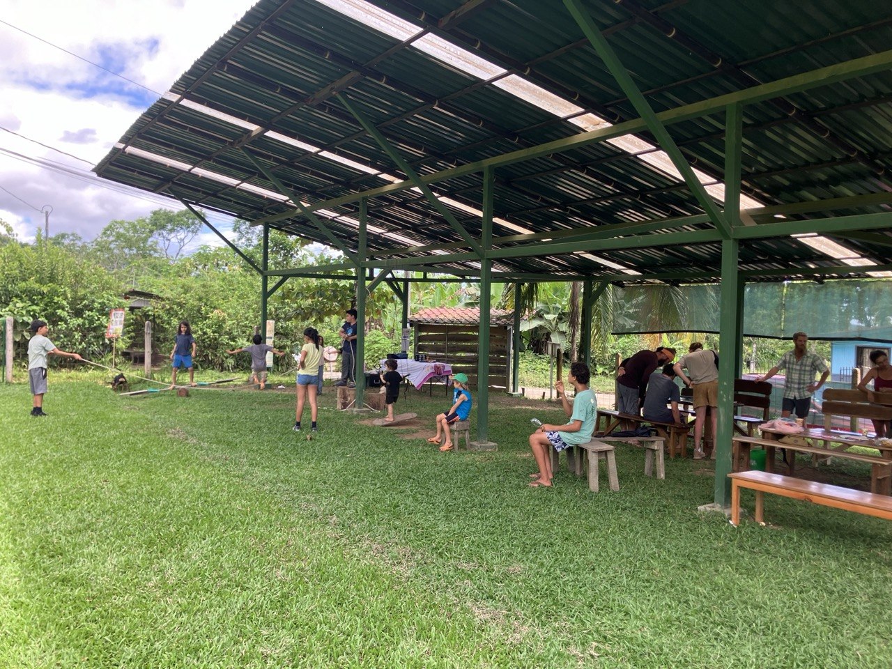 Community gathered together under the roof at Las Tumbas Centro