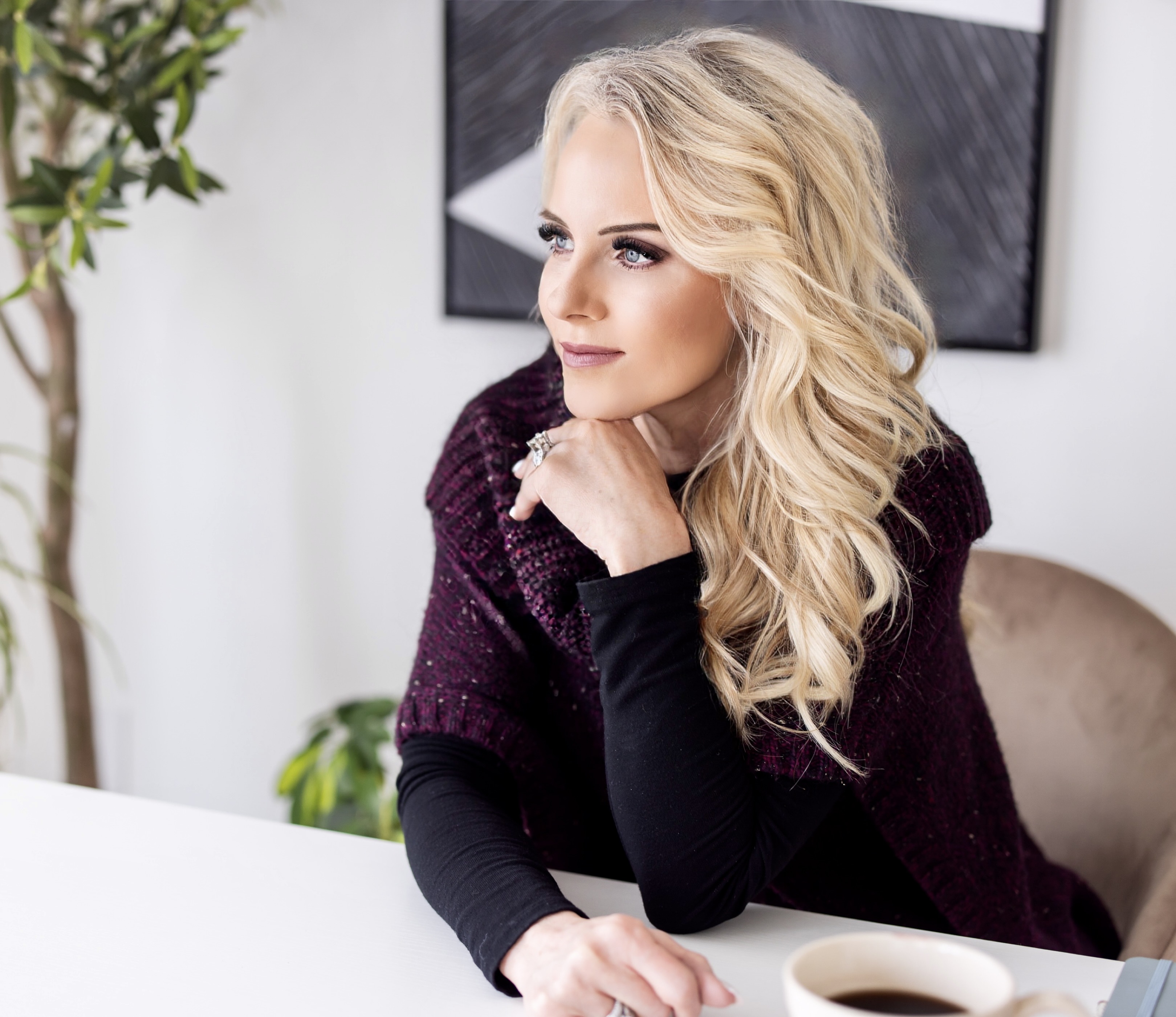 A woman pausing to think at her desk