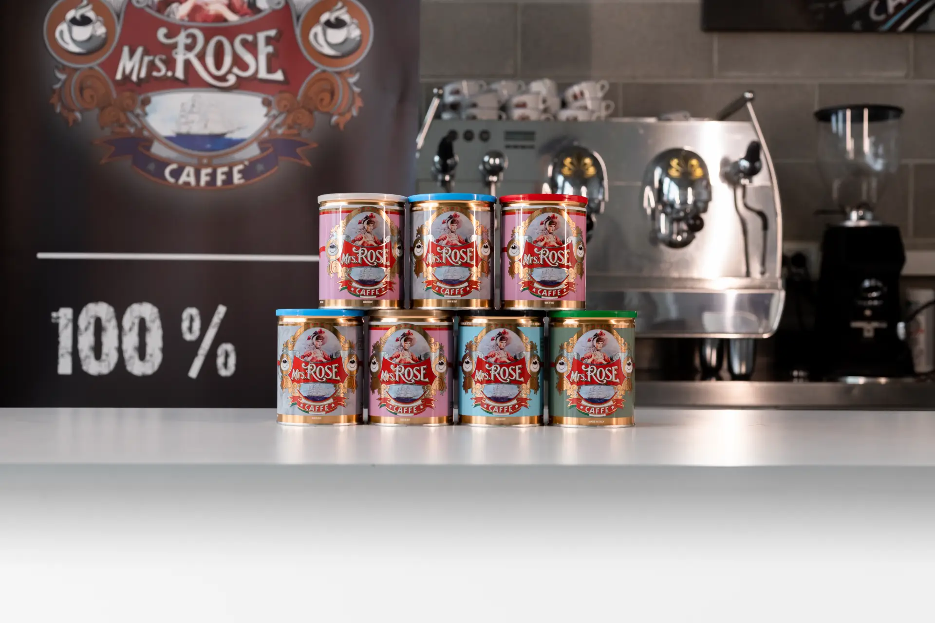Mrs. Rose tins on a working espresso bar, machine and cups in view