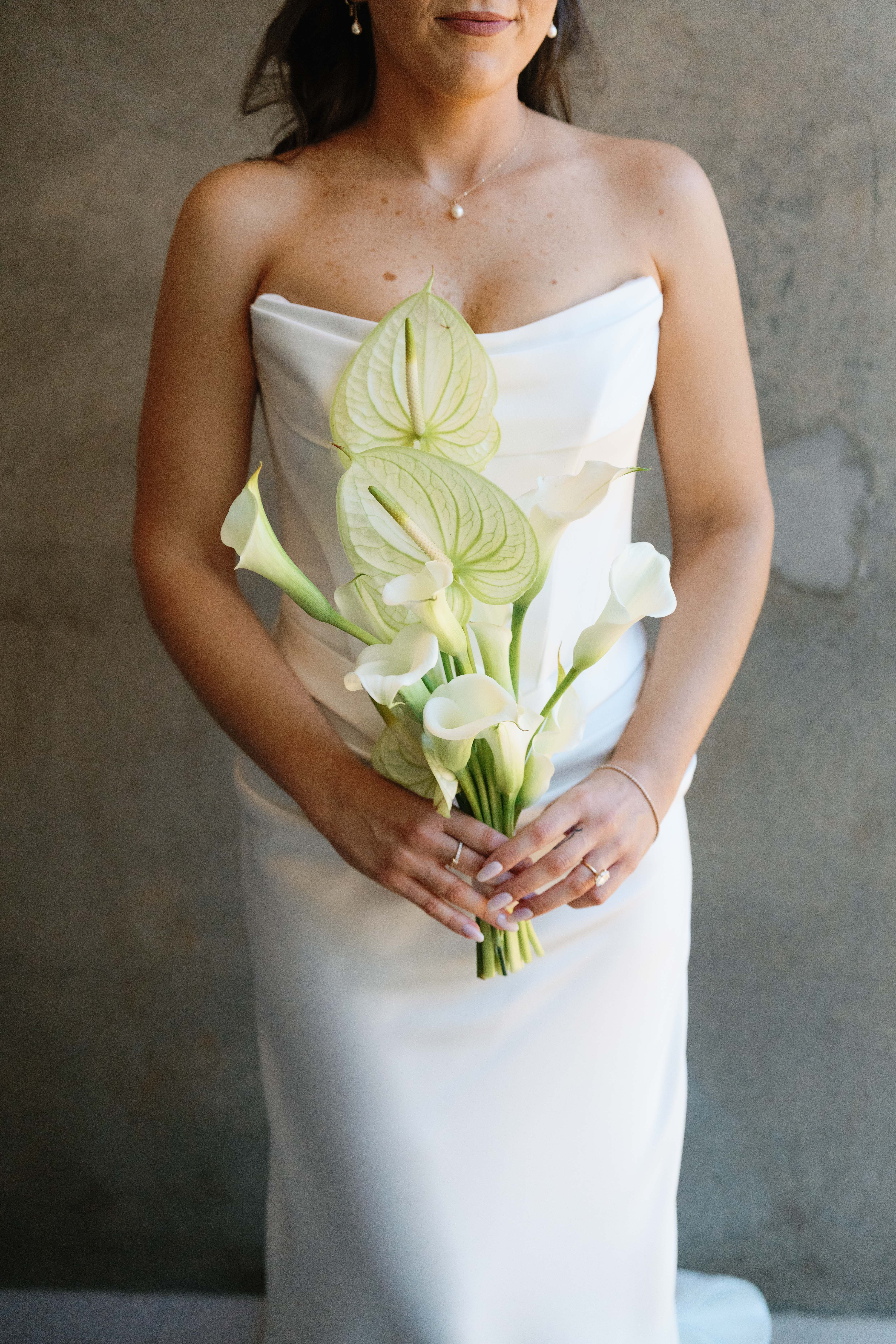 Bride holding white calla lilies