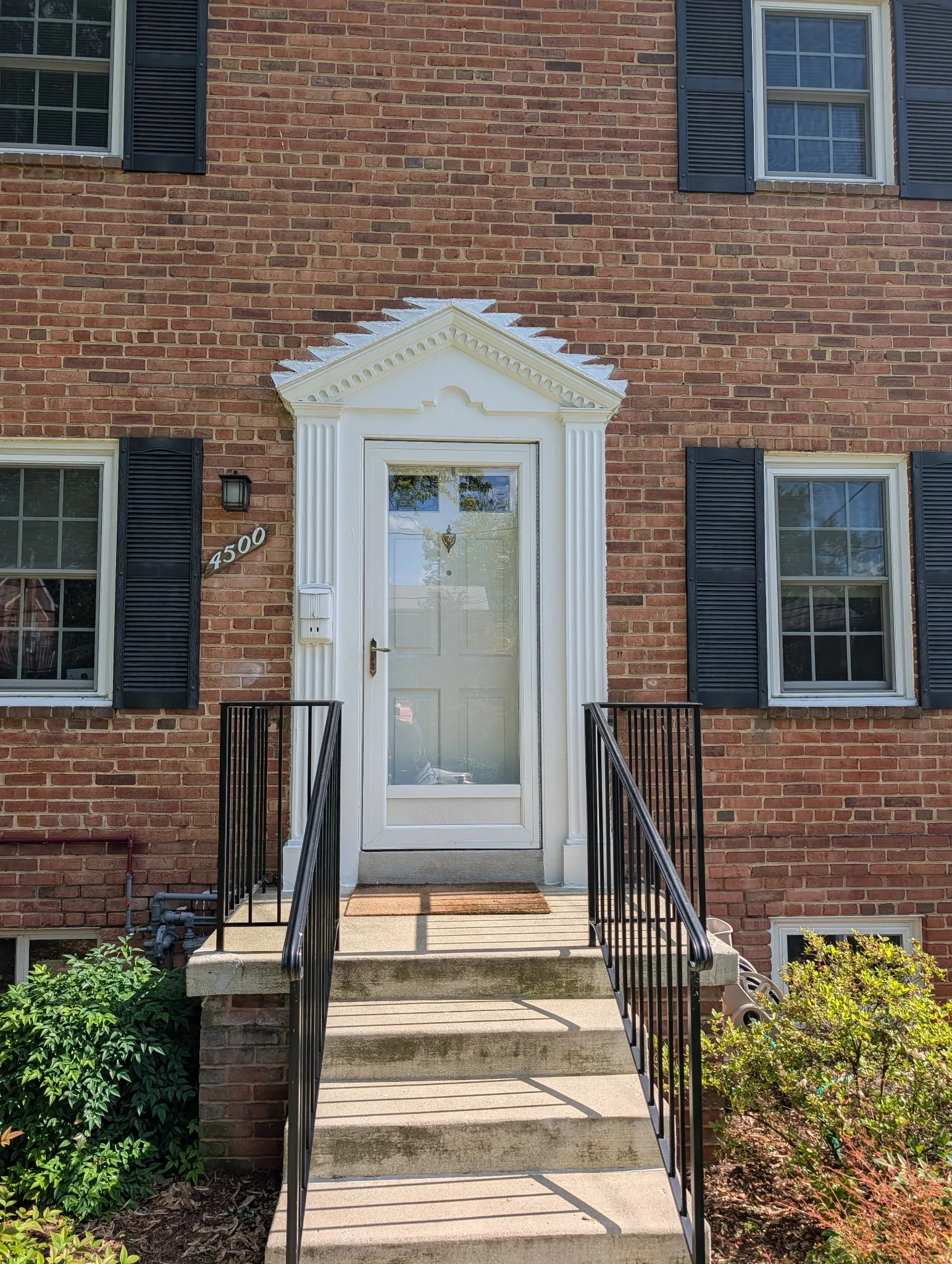 Vinyl replacement windows with grids on a colonial home