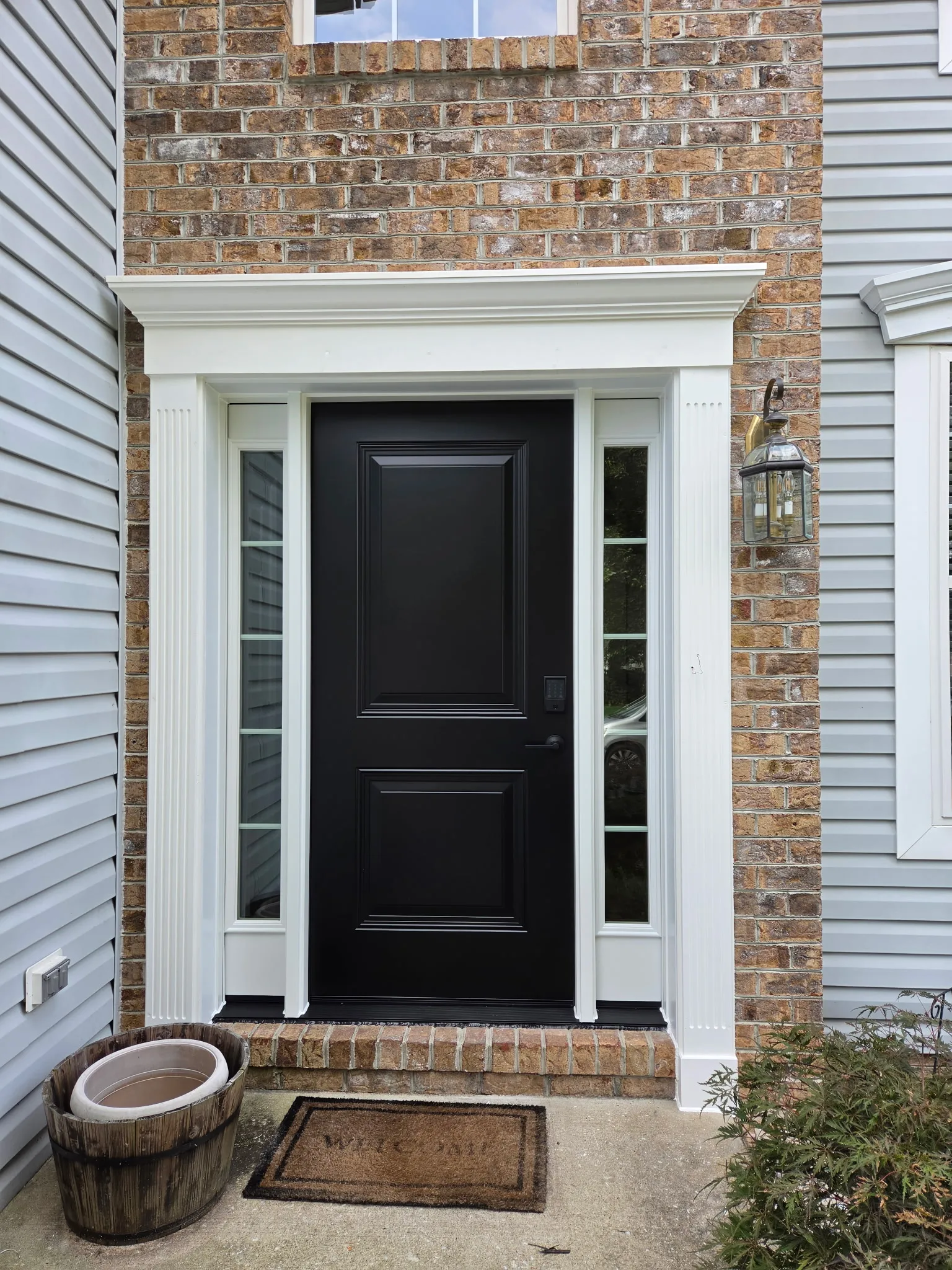 Home exterior renovation with new siding, windows, and entry door