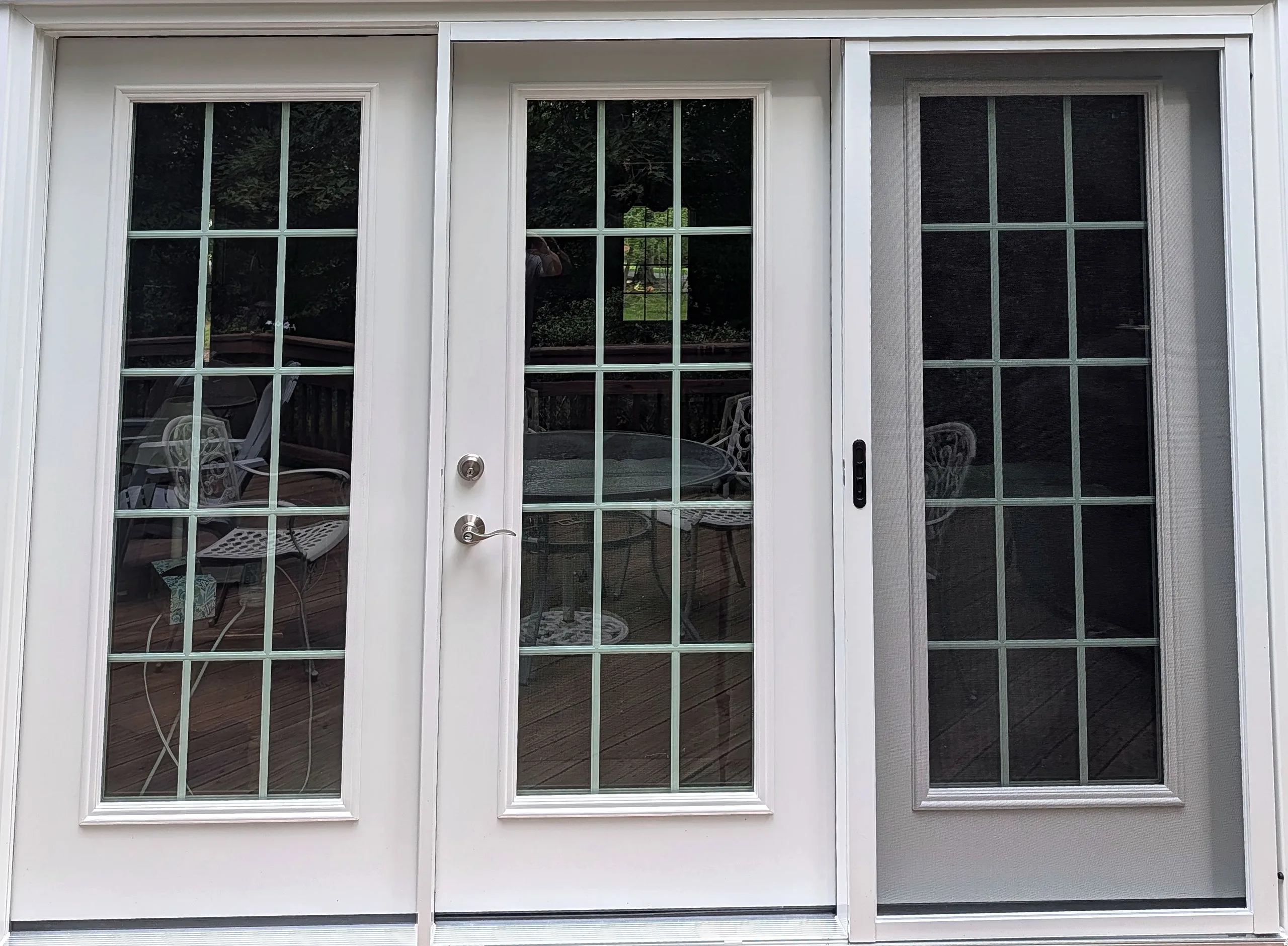 Steel entry door with decorative glass on a residential front porch