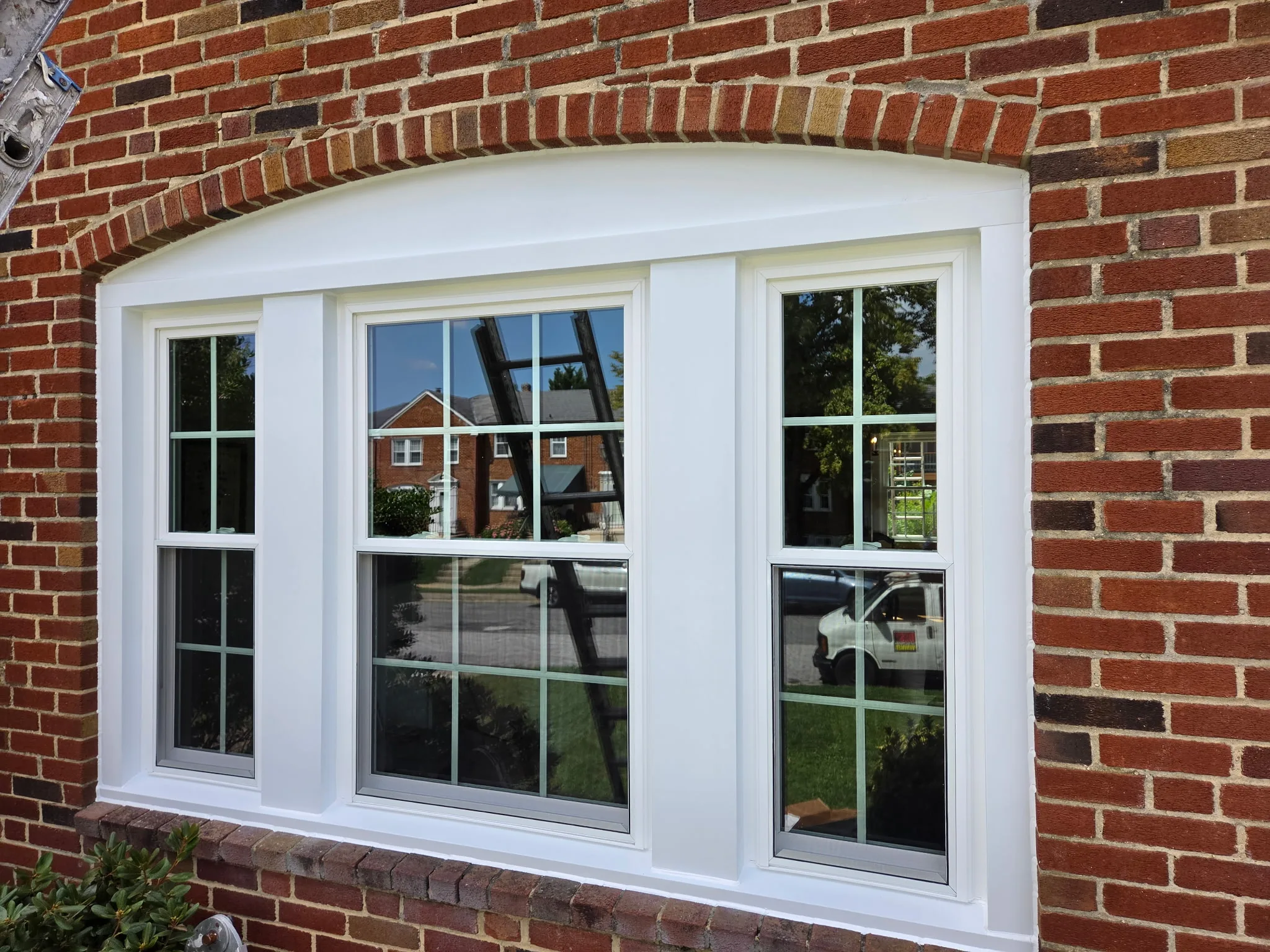 White vinyl replacement windows on a Maryland home exterior