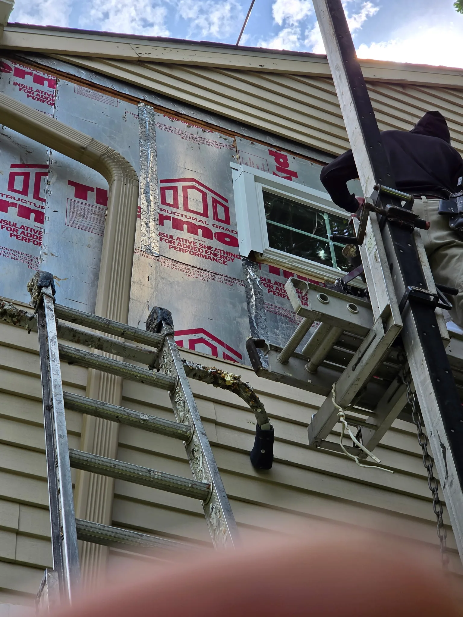 Double-hung replacement windows with exterior capping and trim