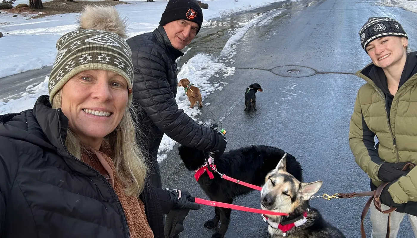 Kiersten on a snowy winter walk with family and their dogs