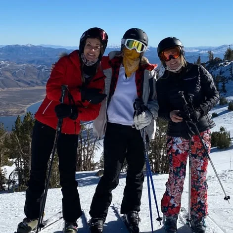 Kiersten skiing with friends on a sunny day