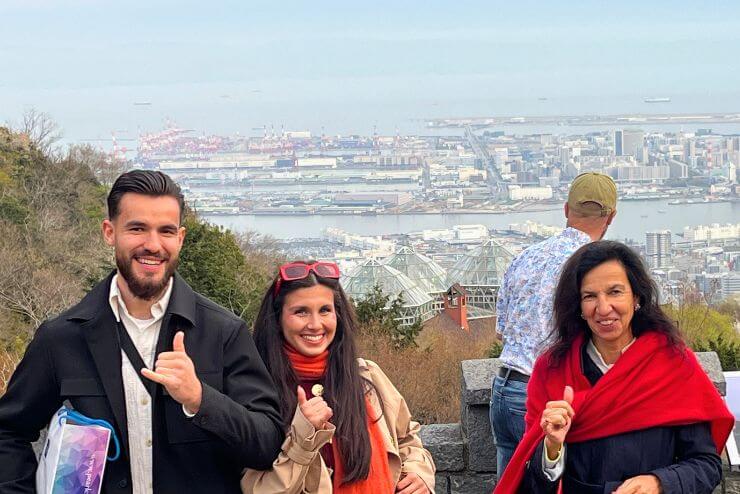 Guest enjoying the view from a temple balcony overlooking Kansai`s skyline and hills