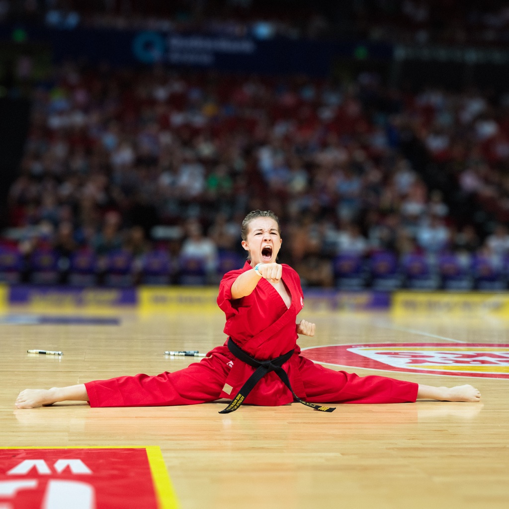 Young performer in splits on court