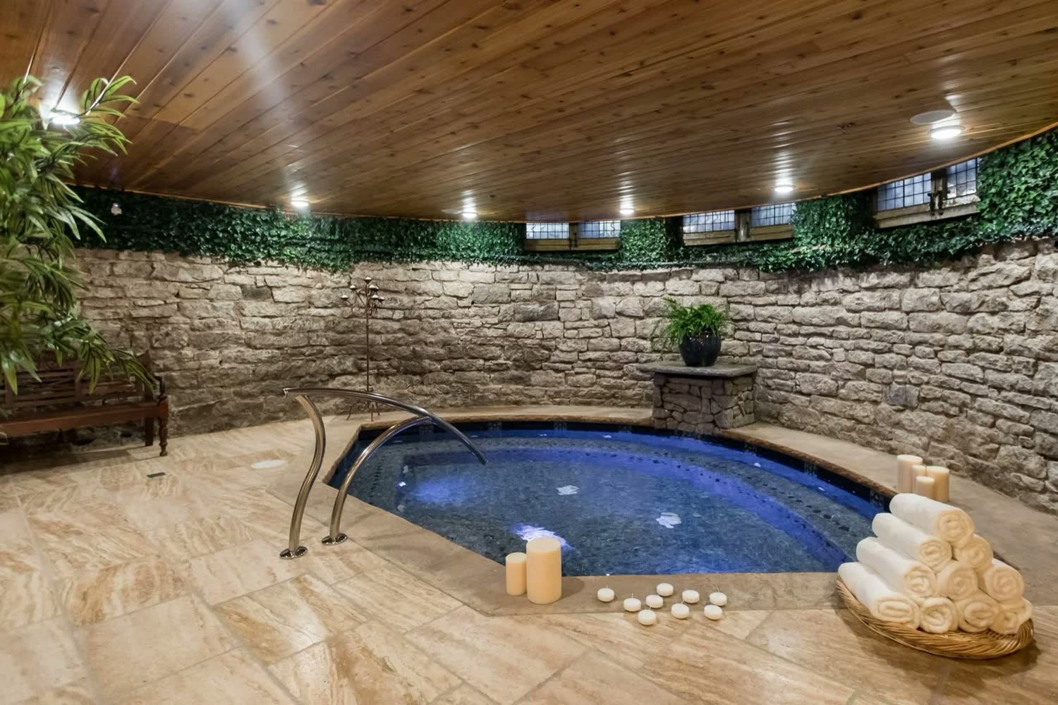 The heated saltwater grotto: a blue pool set in stone walls beneath a wood ceiling