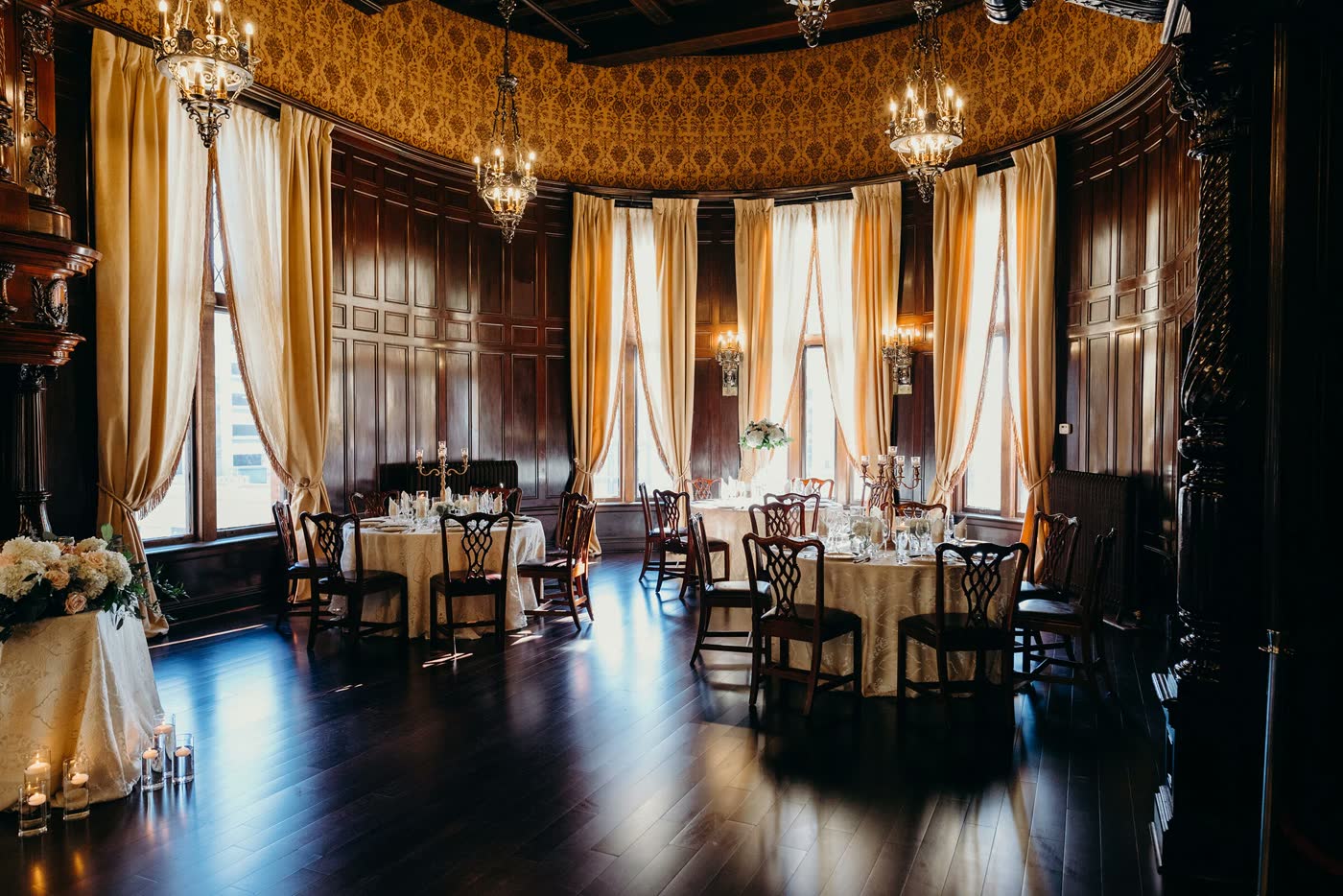 The Presidential Ballroom set with round tables beneath gold drapes