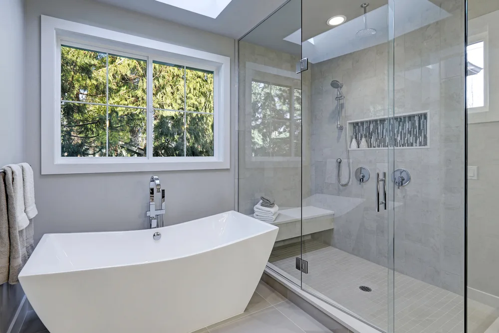 Modern bathroom remodel with freestanding tub and glass shower