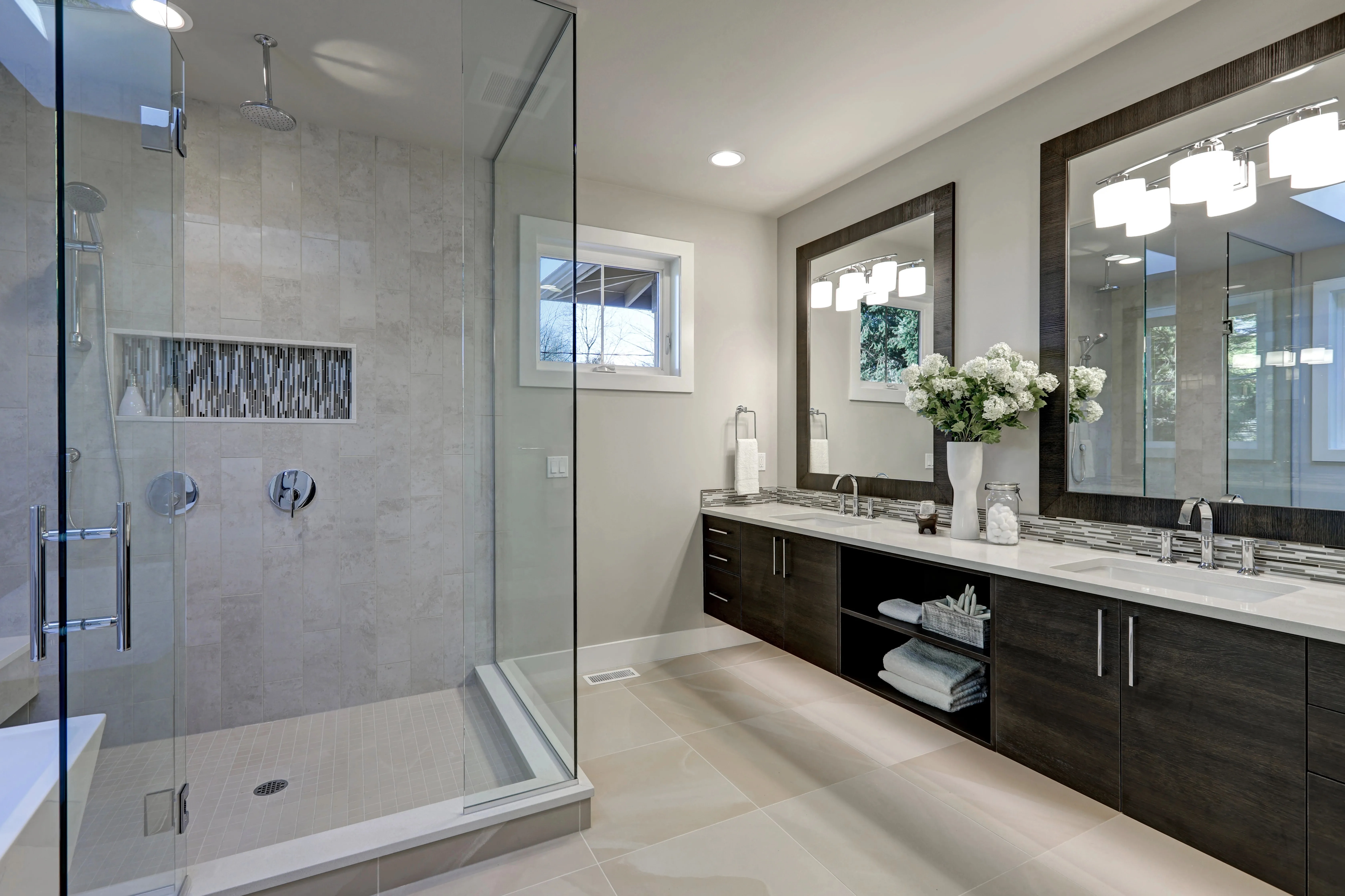 Modern bathroom renovation with glass shower and double vanity