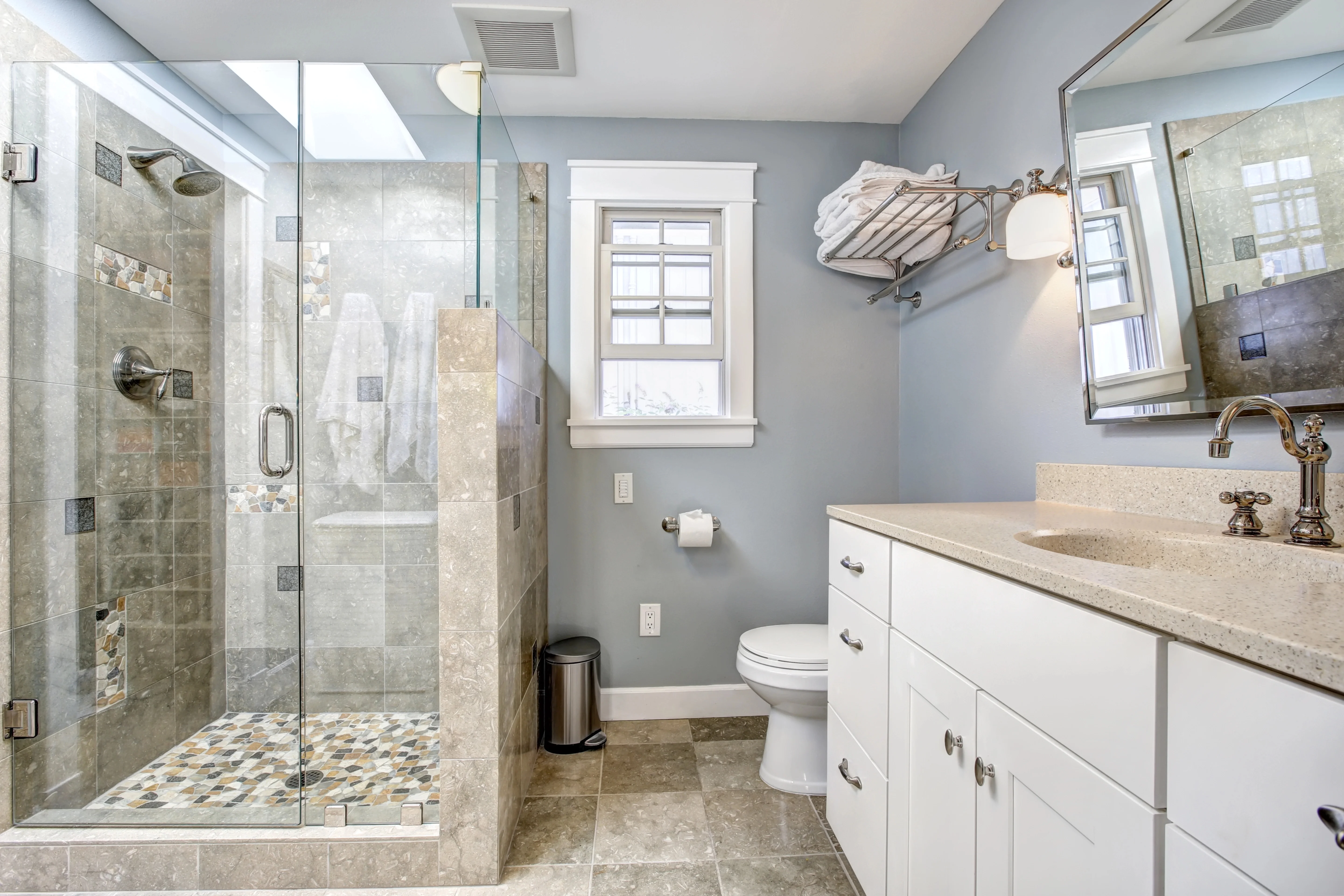 Completed bathroom remodel with tiled walk-in shower