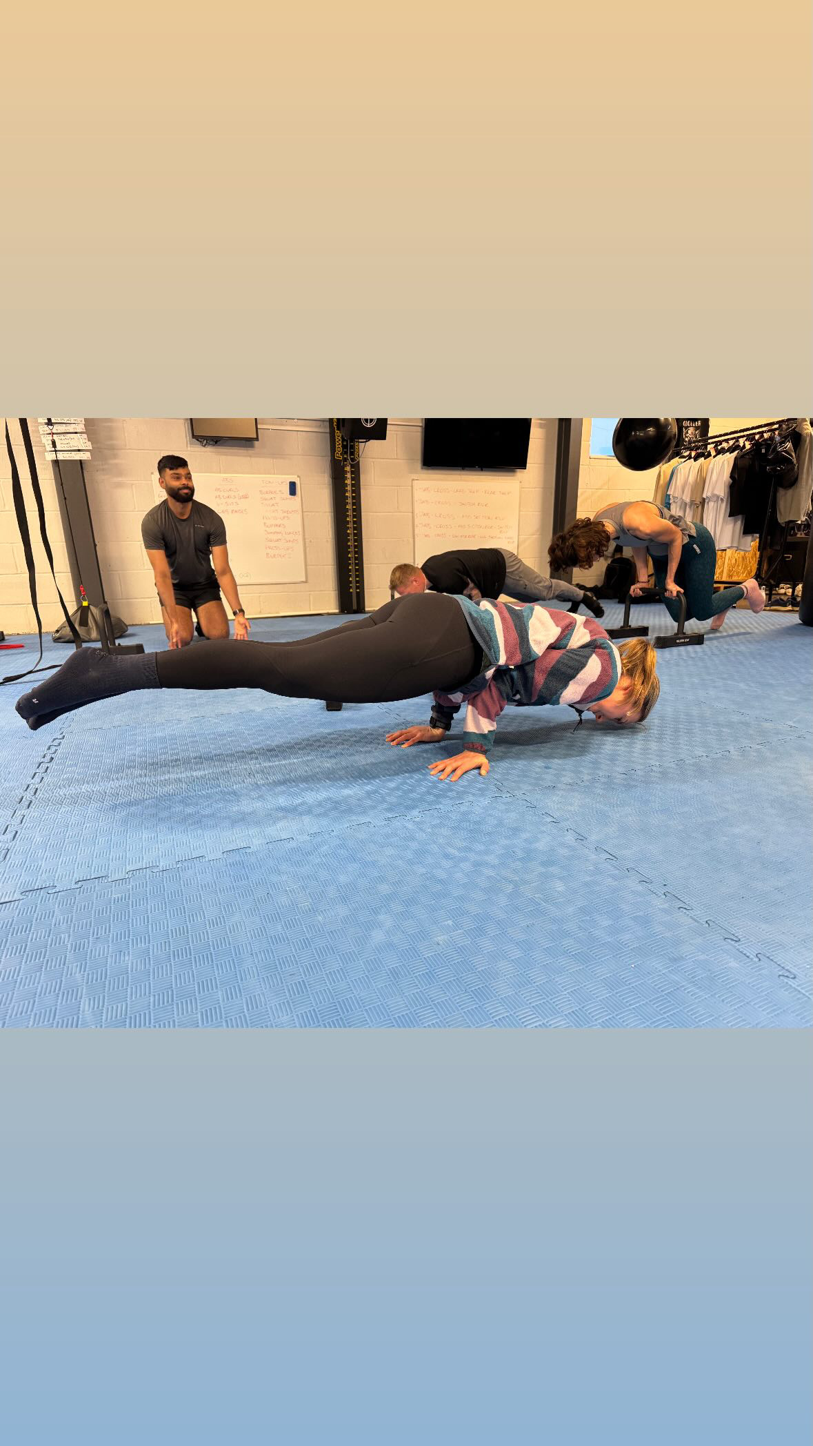 Members practising controlled bodyweight movements in the indoor gym