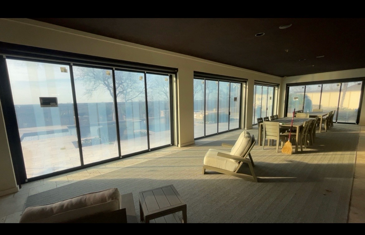 Lake-view room with wall of sliding glass doors