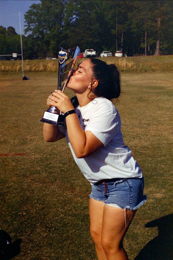 Brieanna Carlson with a rugby trophy