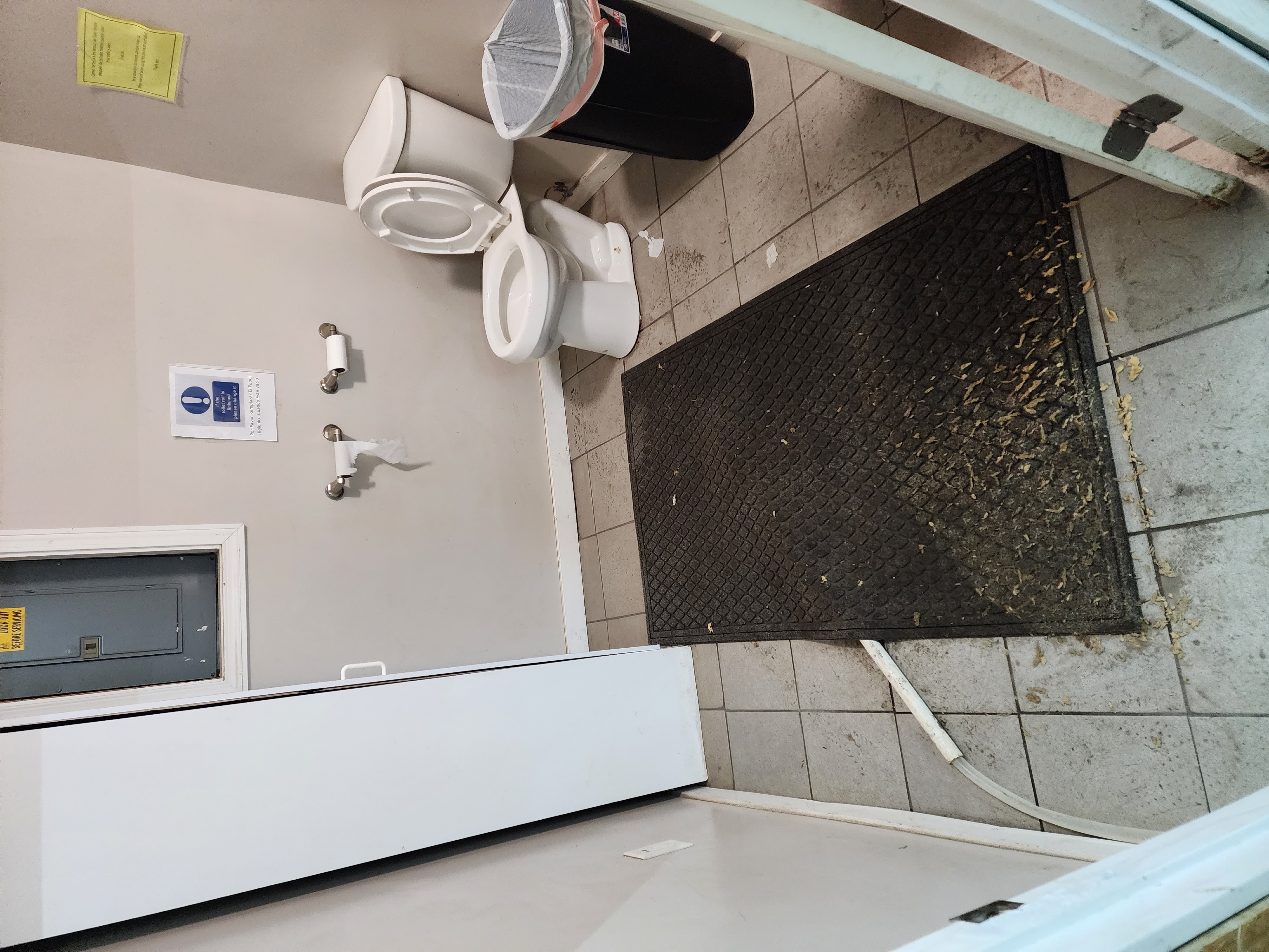 Garage bathroom before cleaning - debris on floor