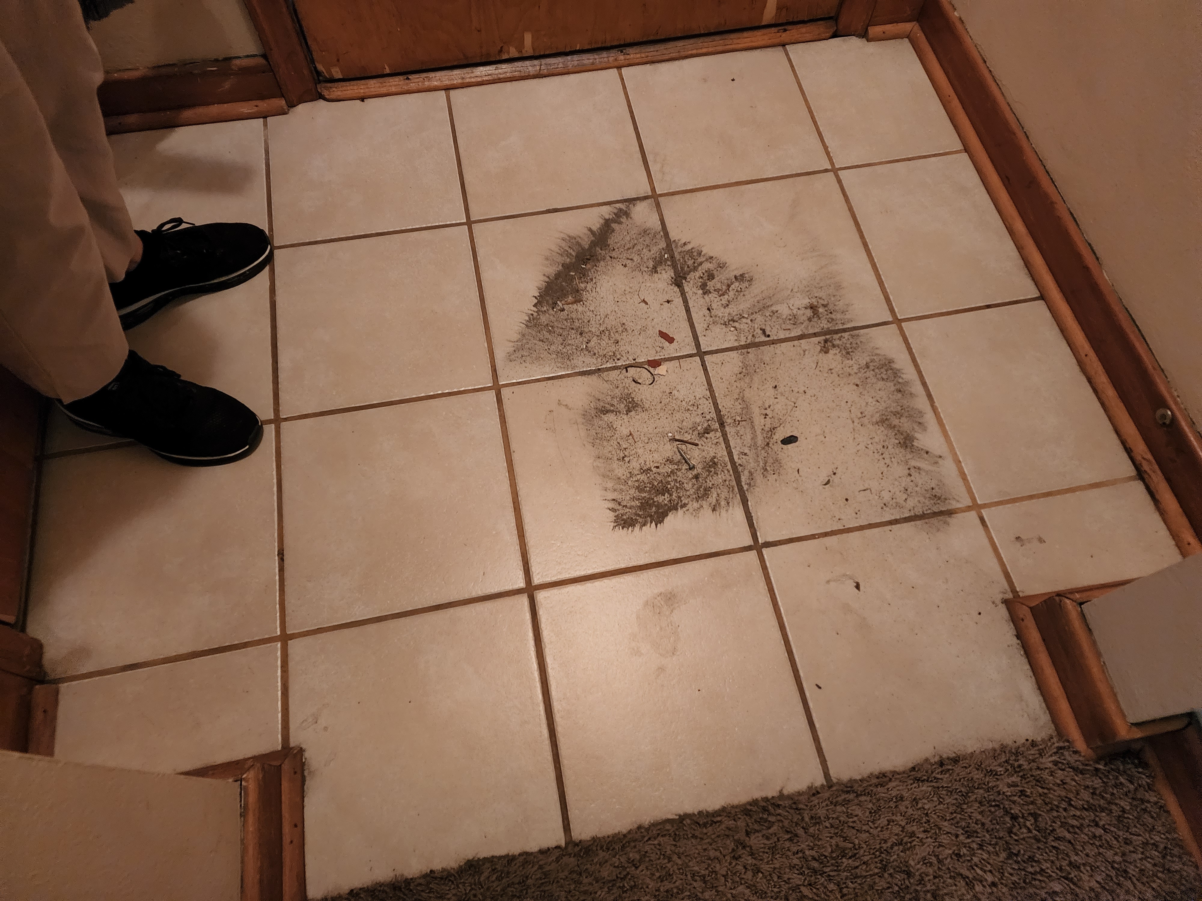 Floor tile before cleaning - heavy staining