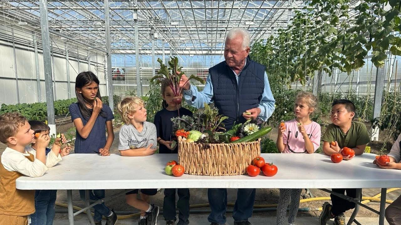 Residents in the garden, greenhouse, or hands-on EcoLearn workshop at The Promised Land Community