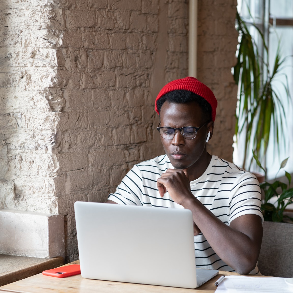 African working remotely in a cafe