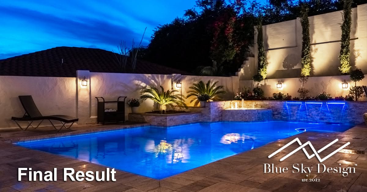 A finished custom inground pool on a Cave Creek desert property, with natural stone coping and desert-integrated landscaping surrounding the pool deck. The Sonoran Desert terrain and open sky are visible in the background.
