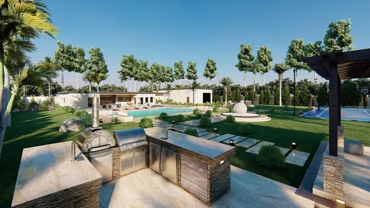 A custom outdoor kitchen installed by Blue Sky Designs in a Cave Creek, AZ backyard, featuring a built-in grill station, heat-resistant countertops, and a pergola shade structure set against a desert landscape backdrop.
