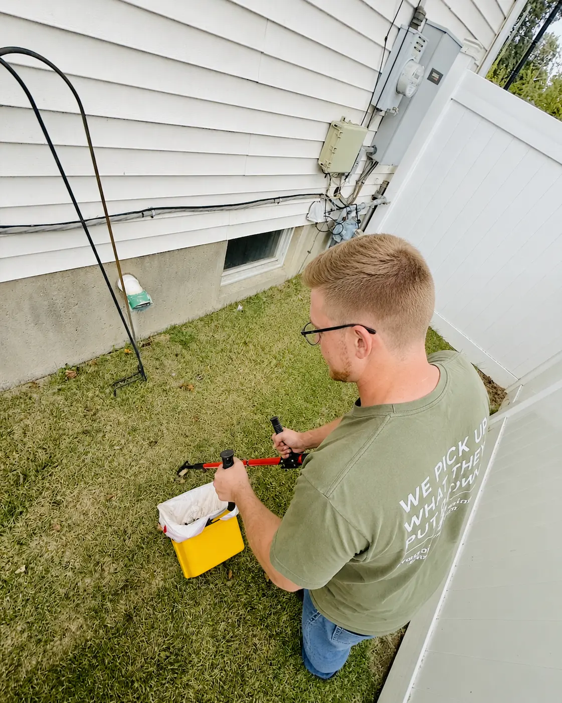 Waggin Waste team member cleaning a residential yard