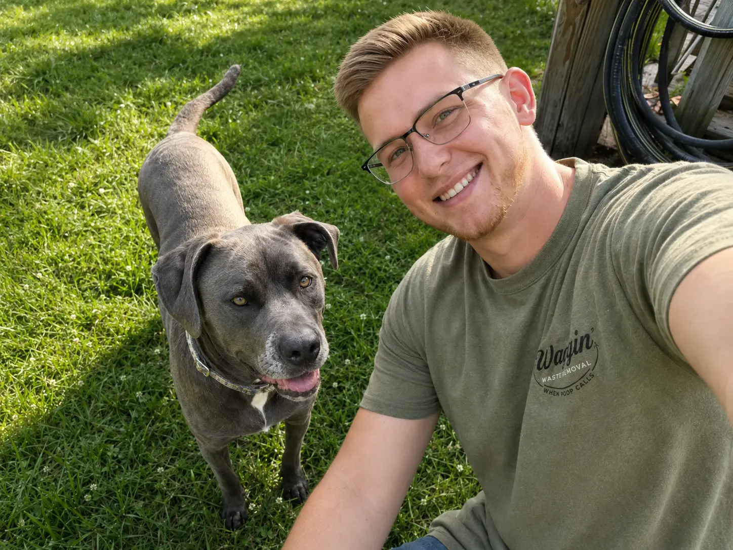 Waggin Waste worker actively scooping a yard during a cleanup visit
