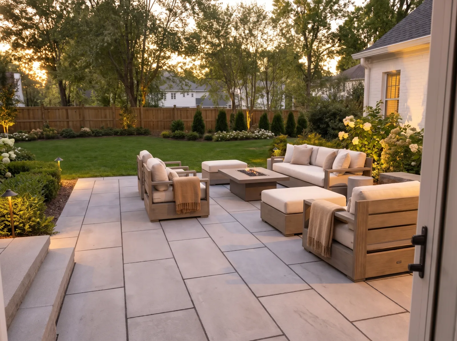 Design concept: Large-format 24-inch slab patio in a light gray, wide joints, modern house, lounge seating, dusk.