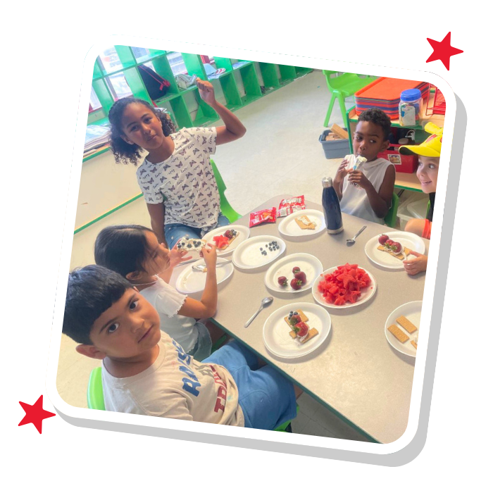 Children enjoying a snack and engaging in a hands-on learning activity at Magic Kingdom Learning Center in Harlingen TX