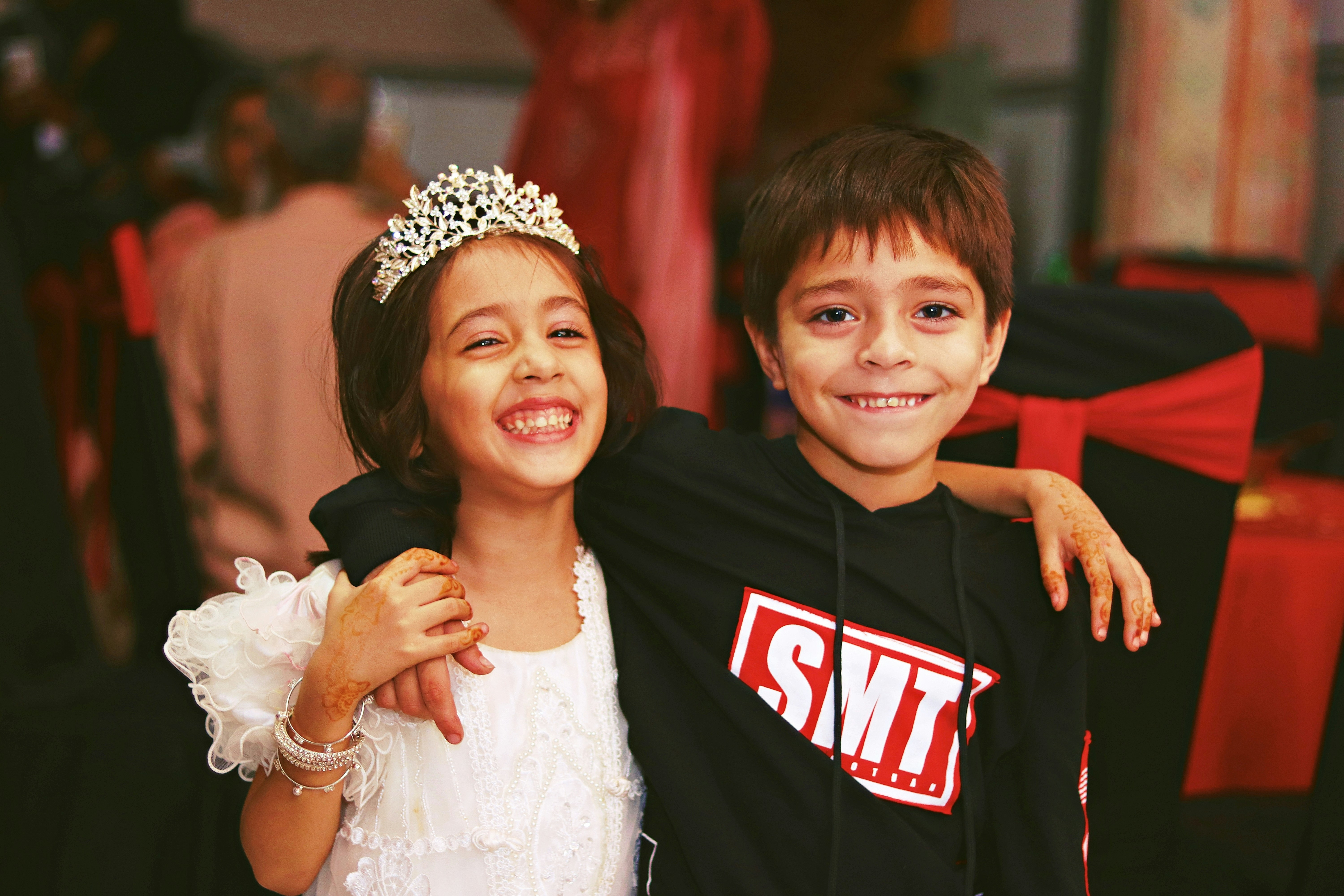 a brother and sister smiling