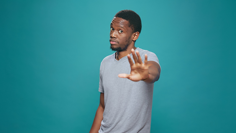 man putting hand up in stopping motion