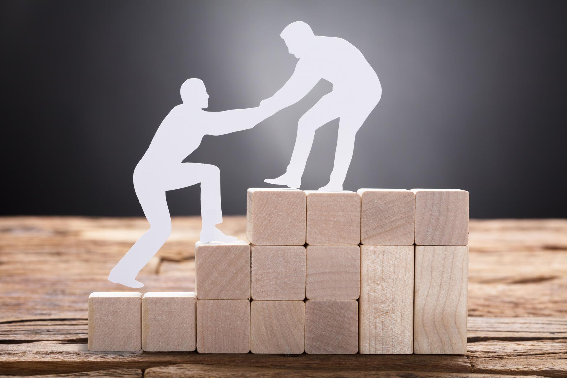 ales coaching mentor helping client climb to the next level of success