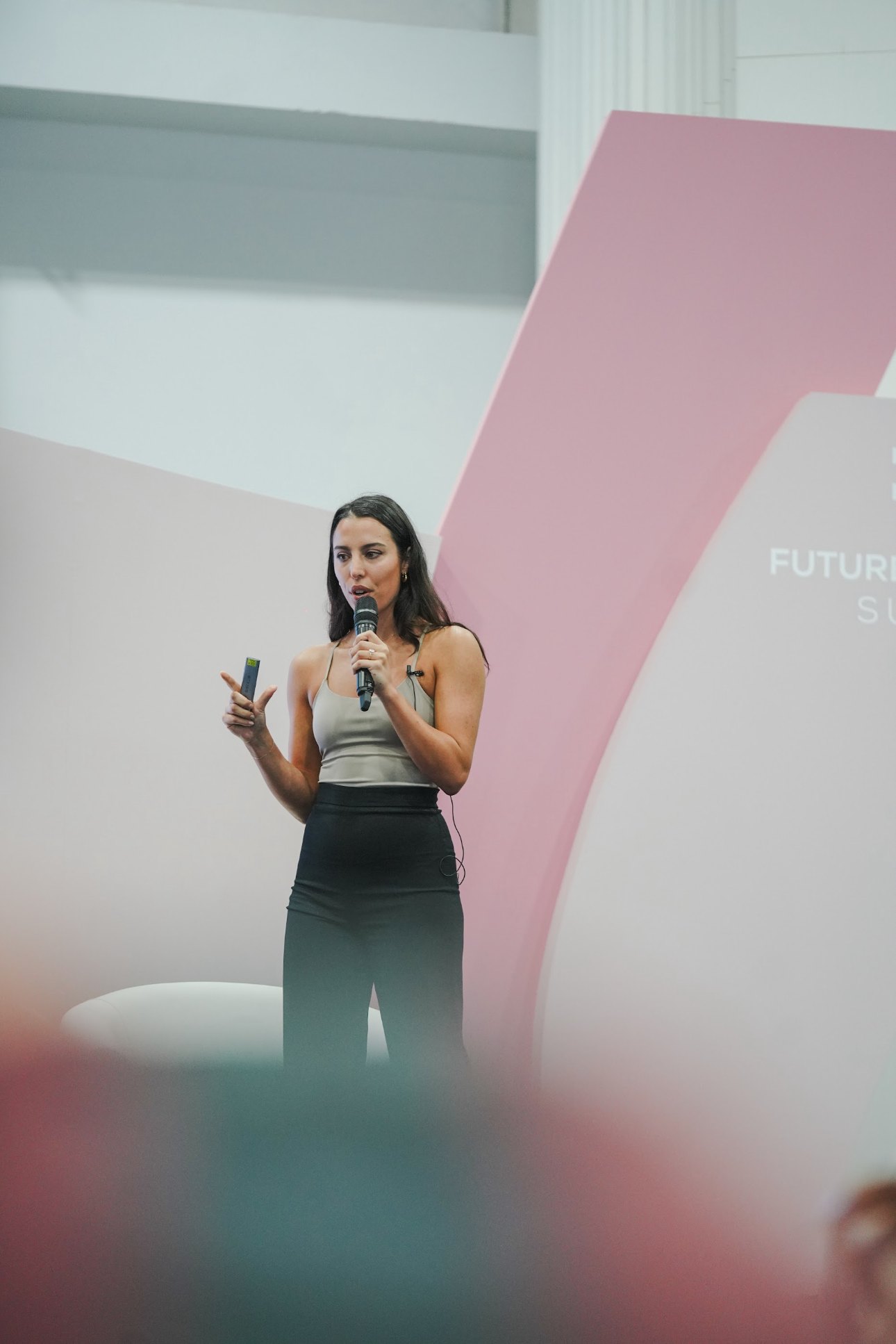 Erika speaking on stage at the Future Wellness Summit