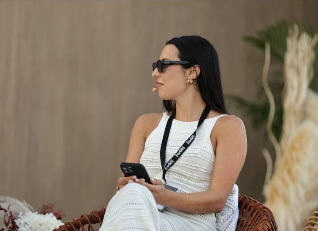 Erika seated on stage at the Forbes Middle East Medical Tourism and Wellness Summit