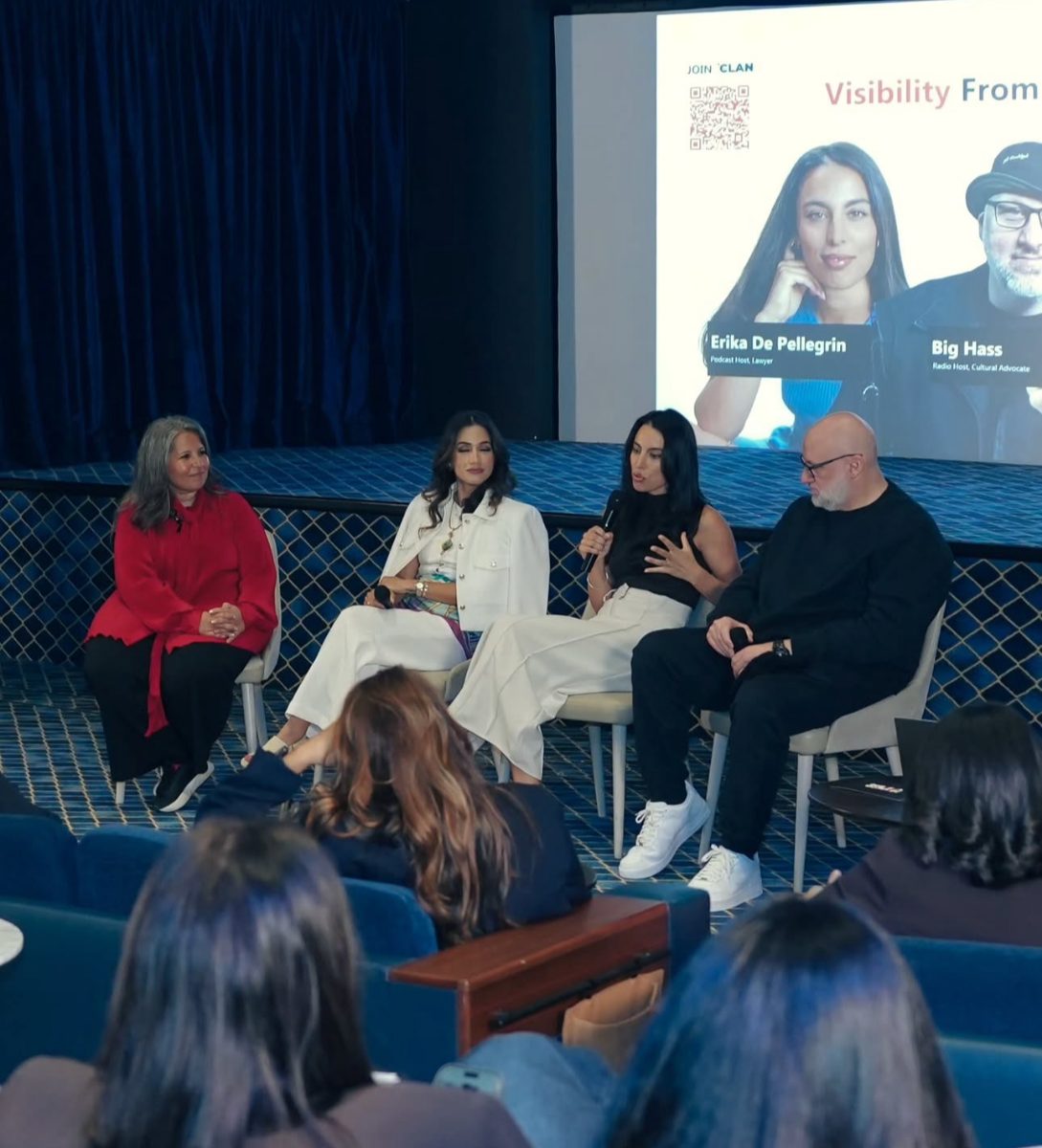 Erika on stage for a panel at Mission Visible's Open Day
