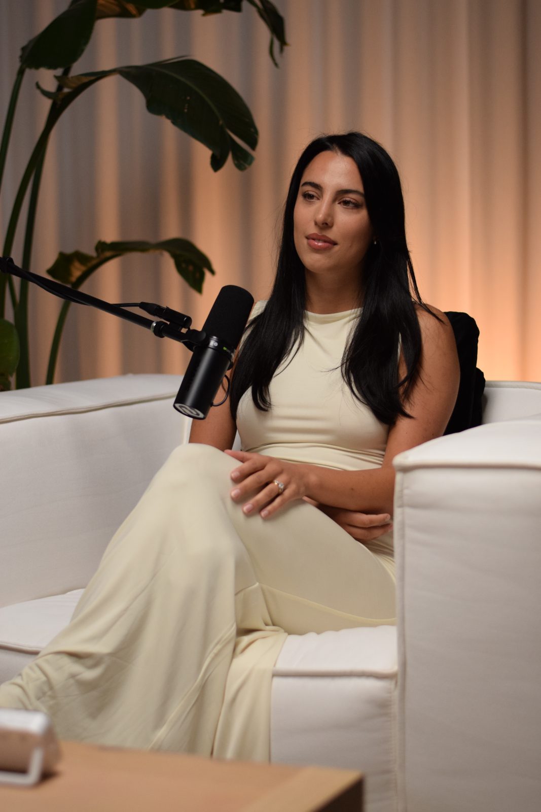 Erika seated at the microphone in the studio