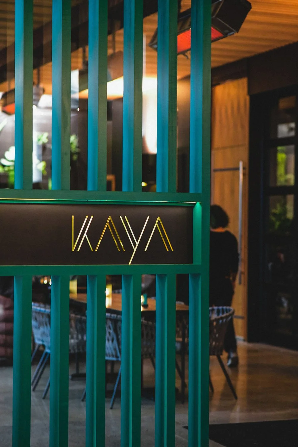Kaya's teal entrance on NE Alberta with the gold KAYA sign