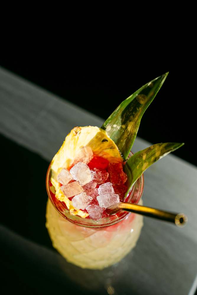 A tiki cocktail with pineapple and pebble ice