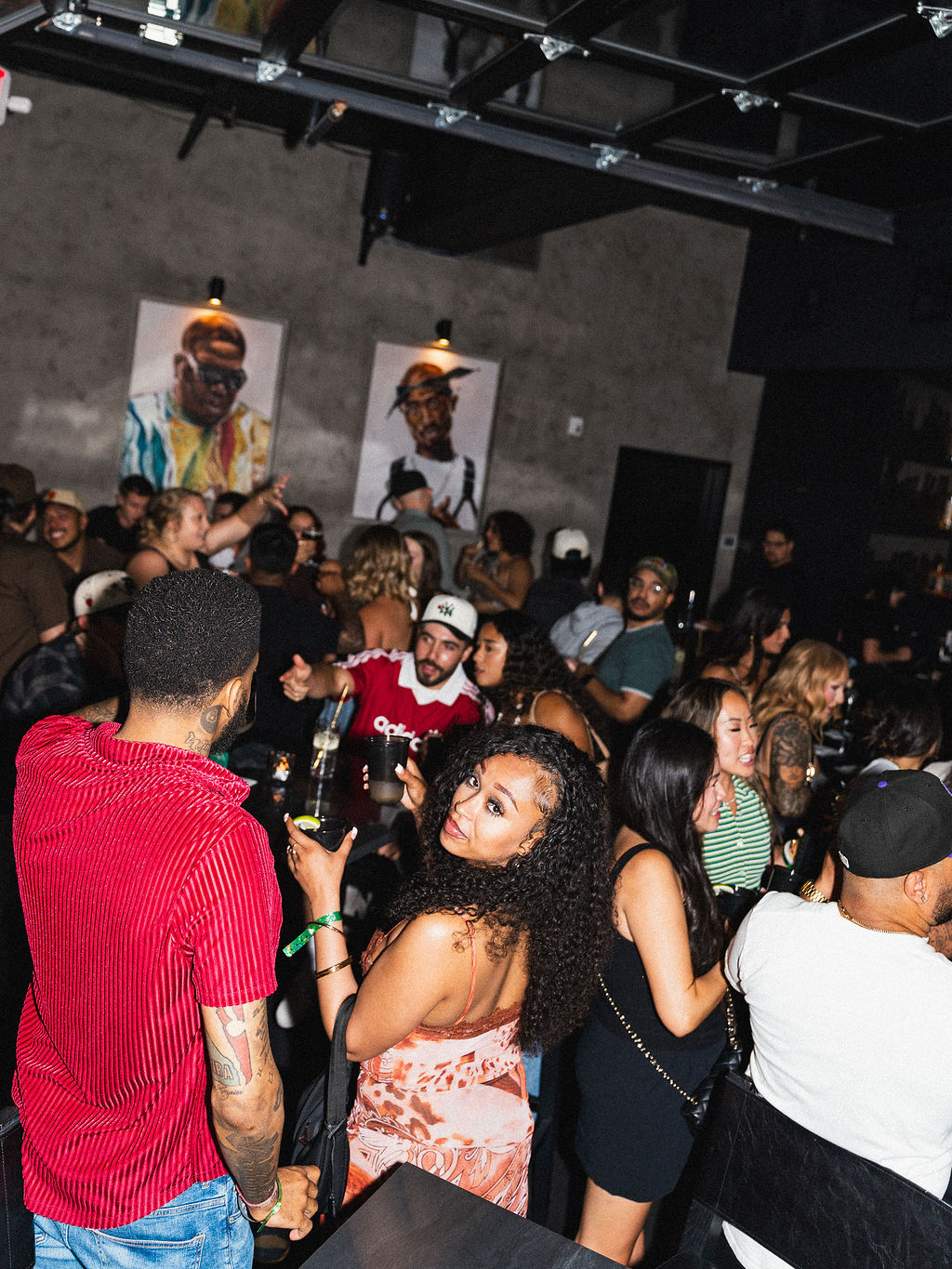 A packed dance floor under the portraits